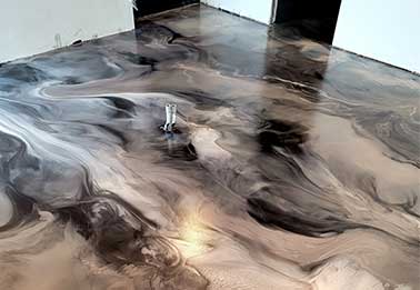 This image shows a metallic epoxy floor that is very shiny.