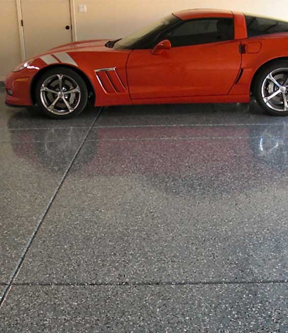 This image shows a garage floor with flake epoxy painted floor.
