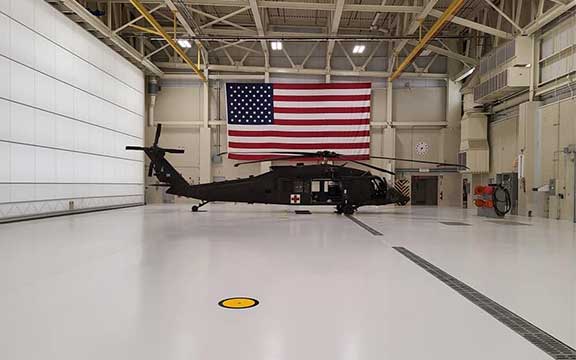 This image shows a hangar with a white epoxy floor.